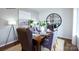 Elegantly decorated dining room with a wooden table, upholstered chairs, and a large round mirror at 1416 6Th Ne St, Hickory, NC 28601
