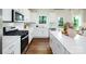 This spacious kitchen features stainless steel appliances, white cabinetry and a large center island at 1416 6Th Ne St, Hickory, NC 28601