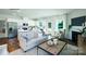 Open-concept living room and kitchen area with modern furnishings and a fireplace at 1416 6Th Ne St, Hickory, NC 28601