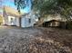 Backyard of a white home with a detached carport and dense foliage at 148 Center St, Chester, SC 29706