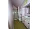 Small bathroom with a shower, toilet, sink and vanity, and overhead storage on pink walls at 148 Center St, Chester, SC 29706