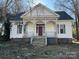 Charming two-story home featuring a classic front porch with decorative trim details at 148 Center St, Chester, SC 29706