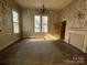 Vacant room features hardwood floors, fireplace and two large windows at 148 Center St, Chester, SC 29706
