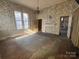 Empty room with hardwood floors, fireplace and original wallpaper at 148 Center St, Chester, SC 29706