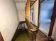 Interior staircase featuring original wood trim, railing, and green carpet at 148 Center St, Chester, SC 29706