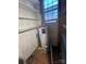 Utility room featuring a hot water heater, shelves and a window at 148 Center St, Chester, SC 29706