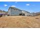 A spacious fenced backyard featuring a covered patio perfect for entertaining and outdoor relaxation at 155 Autumnwood Rd, Troutman, NC 28166