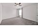 Well-lit bedroom with carpet flooring, natural light, and a ceiling fan at 155 Autumnwood Rd, Troutman, NC 28166