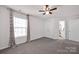 Bright bedroom with a large window, cozy carpet, and a ceiling fan at 155 Autumnwood Rd, Troutman, NC 28166