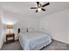 Cozy bedroom with neutral walls, carpet flooring, ceiling fan, and a comfortable bed at 155 Autumnwood Rd, Troutman, NC 28166