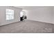 Large, versatile bonus room with neutral carpet, a desk and chair, and plenty of natural light at 155 Autumnwood Rd, Troutman, NC 28166