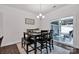 Bright dining area with seating for six and sliding glass doors to a covered outdoor space at 155 Autumnwood Rd, Troutman, NC 28166