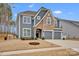 Charming two-story home featuring a mix of stone and gray siding, plus an attached two-car garage at 155 Autumnwood Rd, Troutman, NC 28166