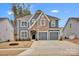 Charming two-story home featuring a mix of stone and gray siding, plus an attached two-car garage at 155 Autumnwood Rd, Troutman, NC 28166