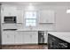 Bright kitchen features white cabinets, stainless appliances, and sleek countertops at 155 Autumnwood Rd, Troutman, NC 28166