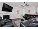 Spacious living room featuring a fireplace, TV, and comfortable leather seating, perfect for relaxation at 155 Autumnwood Rd, Troutman, NC 28166