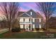 Charming two-story home with covered porch and manicured front yard and professional landscaping at 2200 Trading Ford Dr, Waxhaw, NC 28173