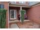 Inviting front porch with rocking chairs, framed by neatly trimmed bushes and brick columns at 2555 Holly Oak Ln, Gastonia, NC 28056