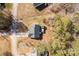 A home with a backyard patio is captured from above, bordered by trees in a quiet neighborhood at 3041 Mulberry Ln, Lancaster, SC 29720