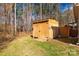 Backyard with a wooden storage shed on a lot with mature trees at 3041 Mulberry Ln, Lancaster, SC 29720