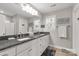 Bright bathroom featuring dual sinks, granite counters, and large mirror at 3041 Mulberry Ln, Lancaster, SC 29720