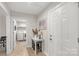 Hallway view featuring hardwood floors, white walls, and access to the laundry room at 3041 Mulberry Ln, Lancaster, SC 29720