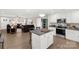 Open kitchen with stainless appliances, granite countertops, and an island open to the cozy living room at 3041 Mulberry Ln, Lancaster, SC 29720