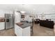 Open-concept kitchen with stainless steel appliances, white cabinets, and an island flowing into the living area at 3041 Mulberry Ln, Lancaster, SC 29720