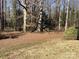 Secluded backyard featuring mature trees, a storage shed, and natural foliage for a tranquil outdoor setting at 314 Little St, Lincolnton, NC 28092
