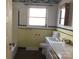Retro bathroom with a large window and vanity at 314 Little St, Lincolnton, NC 28092