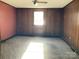Bedroom featuring panel walls, neutral paint, and carpet flooring at 314 Little St, Lincolnton, NC 28092