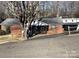 Charming brick home with a screened-in porch and attached carport, nestled among mature trees at 314 Little St, Lincolnton, NC 28092