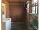 Room with brick wall, shelving, and a freezer at 314 Little St, Lincolnton, NC 28092