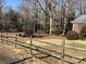 Spacious yard featuring a rustic wooden fence, mature trees, and natural landscaping at 314 Little St, Lincolnton, NC 28092