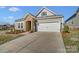 Close up of an attractive home with a stone archway, two-car garage and appealing landscaping at 3501 Tully Ave, Kannapolis, NC 28081