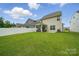 The backyard features a large lawn, a patio and fence at 3899 Center Place Dr, Harrisburg, NC 28075