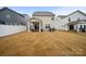 Spacious backyard with a covered patio, fence, and grassy lawn at 3899 Center Place Dr, Harrisburg, NC 28075