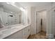 Modern bathroom with dual sinks, granite countertops, white cabinets and tile floors at 3899 Center Place Dr, Harrisburg, NC 28075