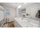 Bathroom with double sinks, modern fixtures, and large mirror at 3899 Center Place Dr, Harrisburg, NC 28075