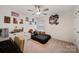 Bedroom with neutral carpet, ceiling fan, and decoratively adorned with posters at 3899 Center Place Dr, Harrisburg, NC 28075