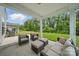 Relaxing covered patio features wicker furniture, providing a cozy space to unwind and appreciate the serene outdoor ambiance at 3899 Center Place Dr, Harrisburg, NC 28075