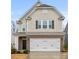 Charming two-story home featuring a brick facade and a convenient two-car garage at 3899 Center Place Dr, Harrisburg, NC 28075