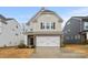 Charming two-story home with a two-car garage, brick accents, and manicured landscaping at 3899 Center Place Dr, Harrisburg, NC 28075