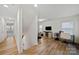 Hallway with wood floors, natural light, and view to office space at 3899 Center Place Dr, Harrisburg, NC 28075