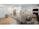 Modern kitchen featuring a large island with seating, stainless steel appliances, and stylish countertops at 3899 Center Place Dr, Harrisburg, NC 28075