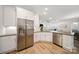 Modern kitchen featuring stainless steel appliances and an open layout to the living room at 3899 Center Place Dr, Harrisburg, NC 28075