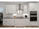 Modern kitchen with white cabinets, granite countertops, a gas range, and stainless steel appliances at 3899 Center Place Dr, Harrisburg, NC 28075