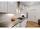Well-appointed kitchen with custom cabinets, stone countertops, stainless steel appliances, and gas cooktop at 3899 Center Place Dr, Harrisburg, NC 28075