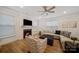 Inviting living room with a fireplace, ceiling fan, plush seating, and ample natural light at 3899 Center Place Dr, Harrisburg, NC 28075