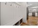 Functional mudroom with built-in storage, hooks, and bench seating, leading to the kitchen at 3899 Center Place Dr, Harrisburg, NC 28075